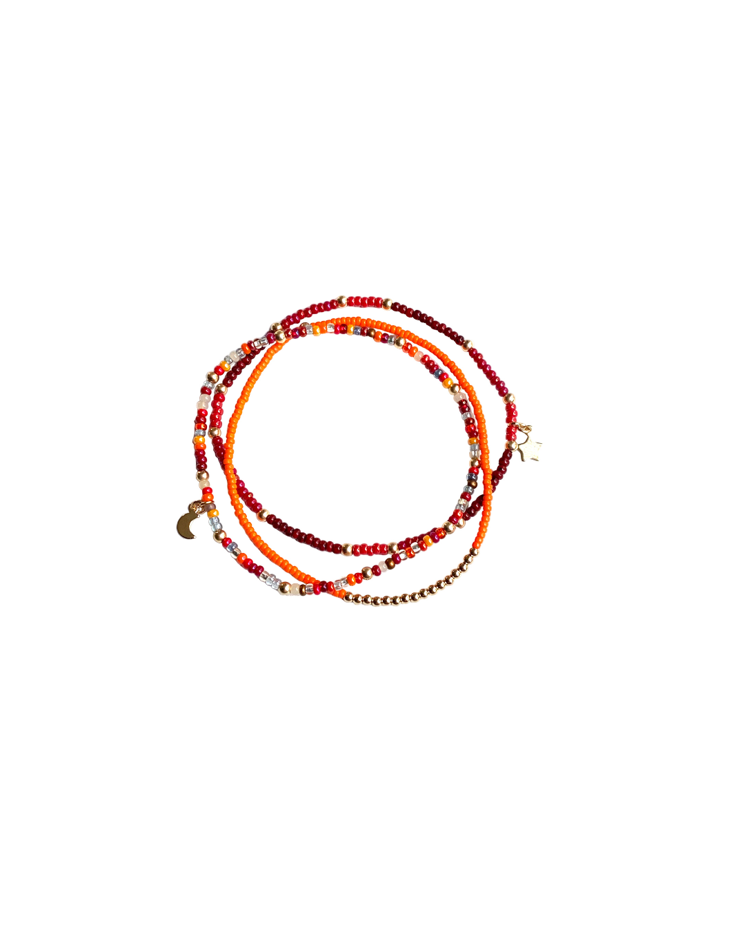 Set of three gold and seed beaded bracelets in orange, red, and gold on a white background