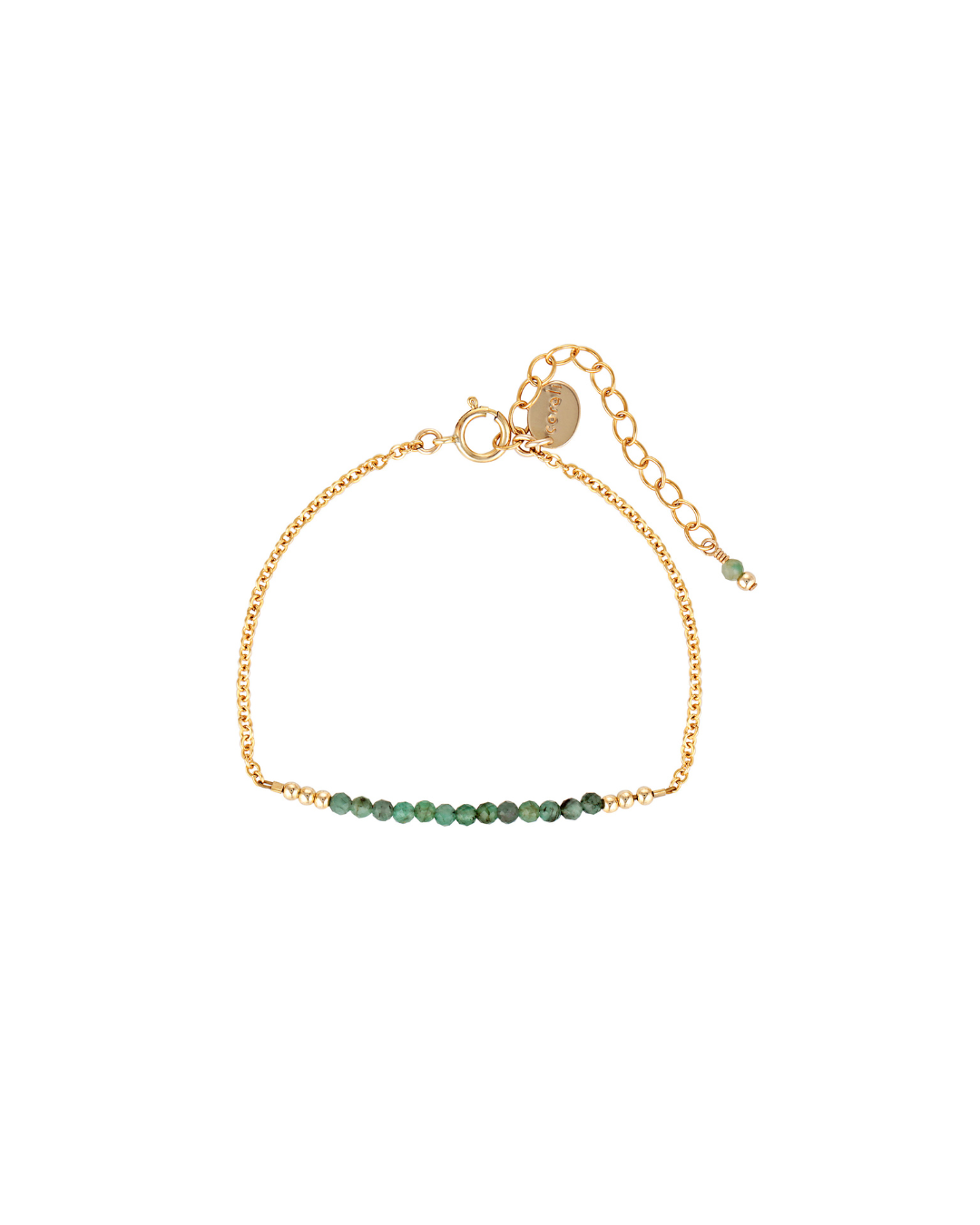 Gold bracelet with emerald gemstones on a white background