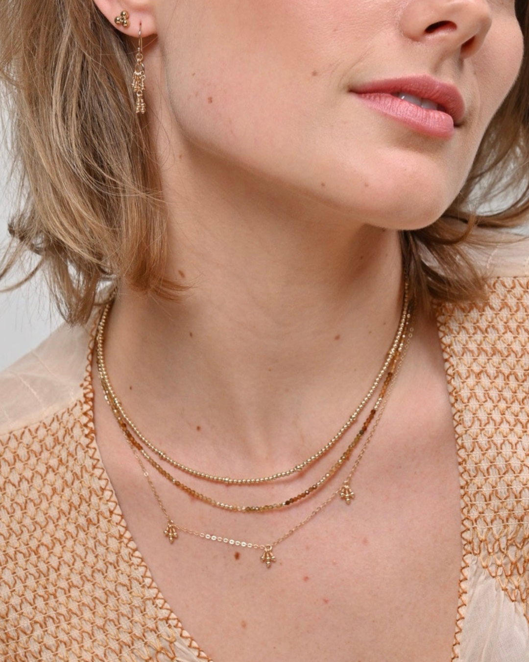 Layered gold necklaces.