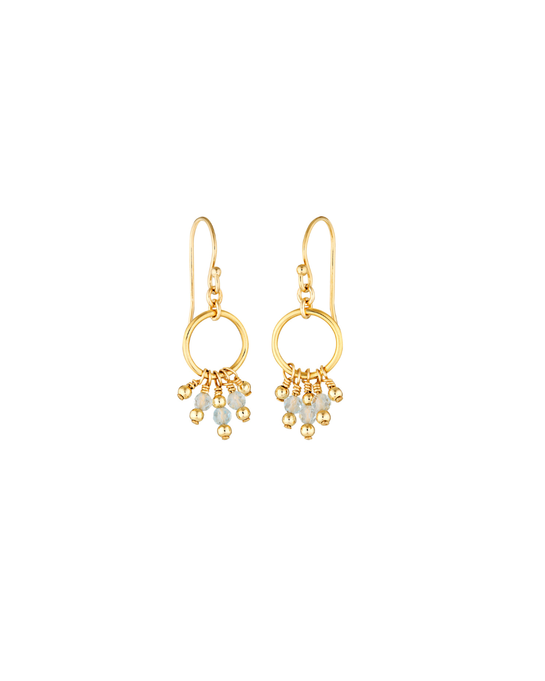 Gold earrings with circular designs and dangling blue topaz gemstones on a white background