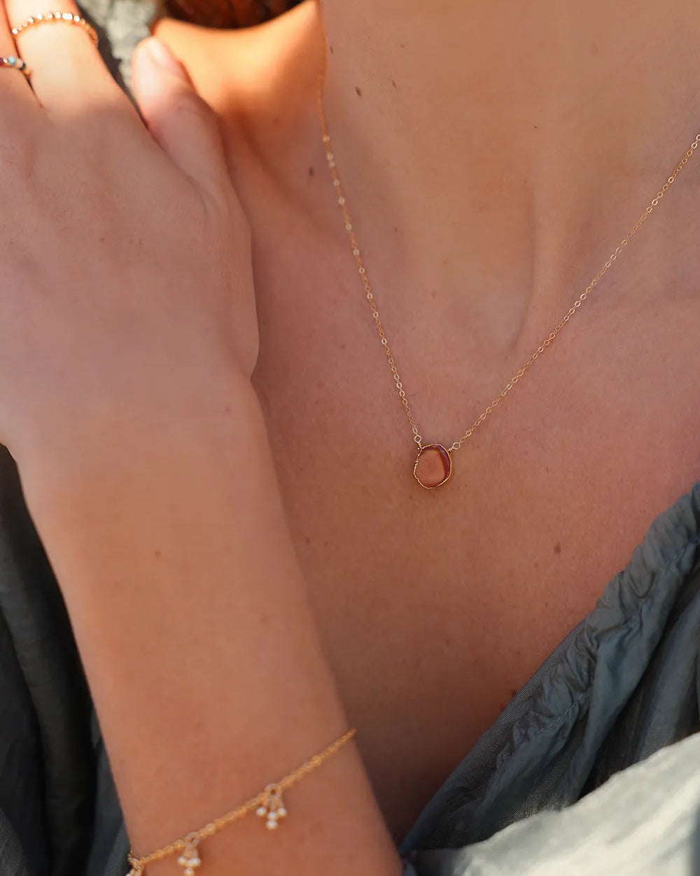 Model wearing Gold necklace with a Carnelian pendant
