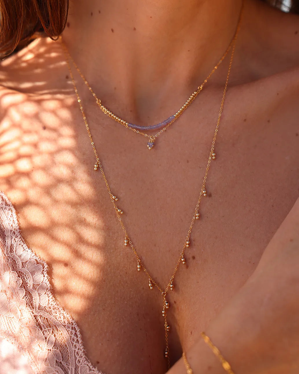 Model wearing Gold lariat necklace with Delicate gold beads