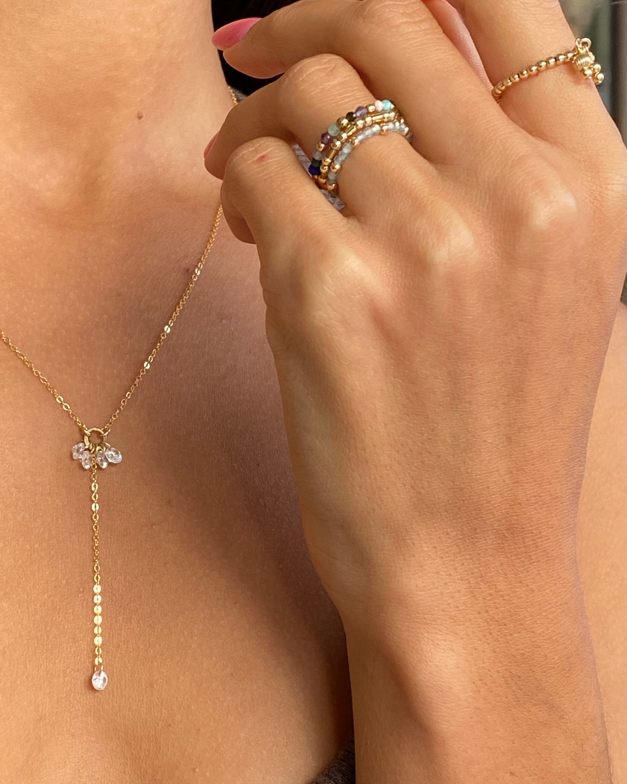 Multi-gem beaded rings on a hand