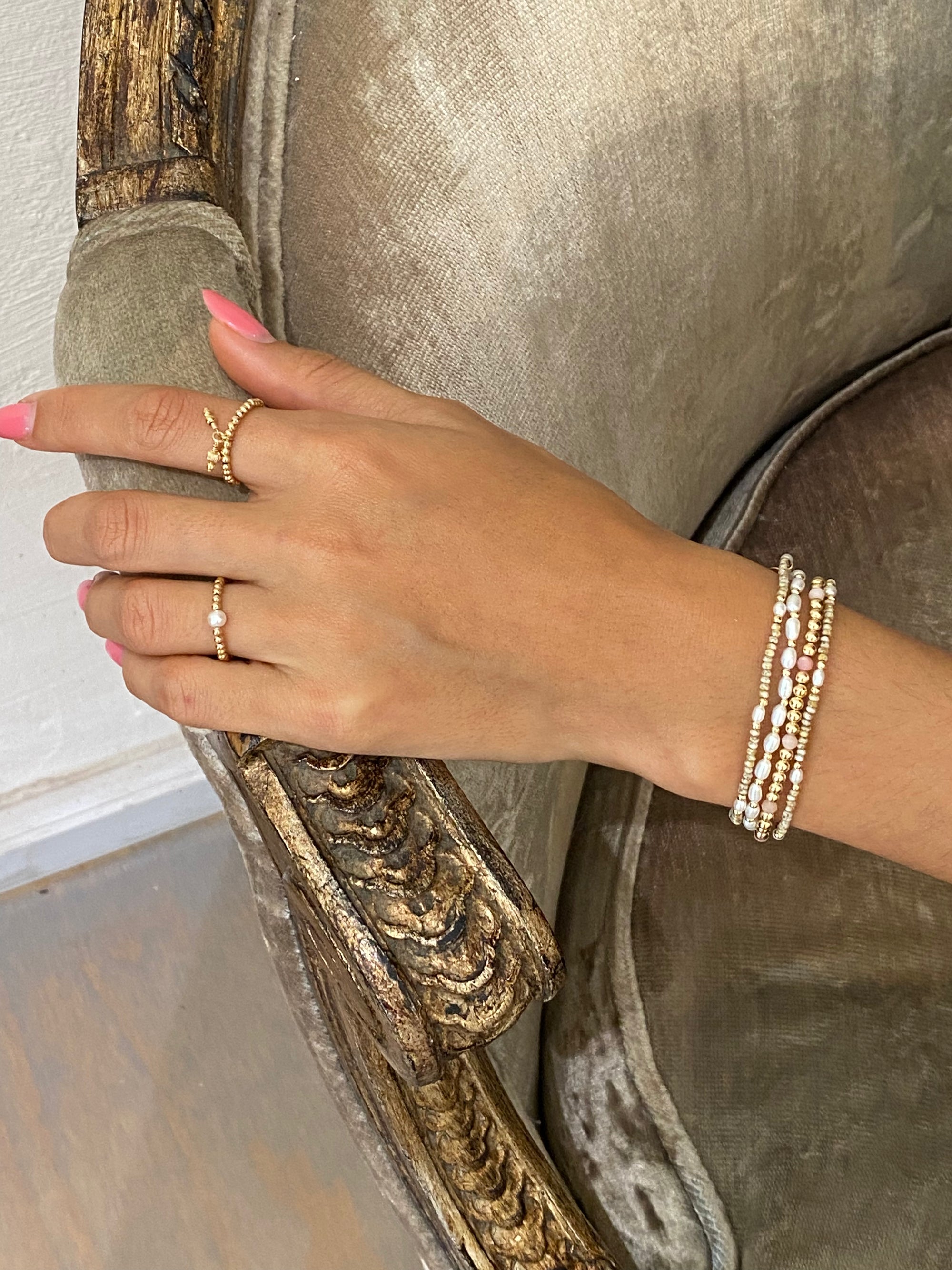 Woman wearing bracelet with freshwater Pearls and gold accent beads