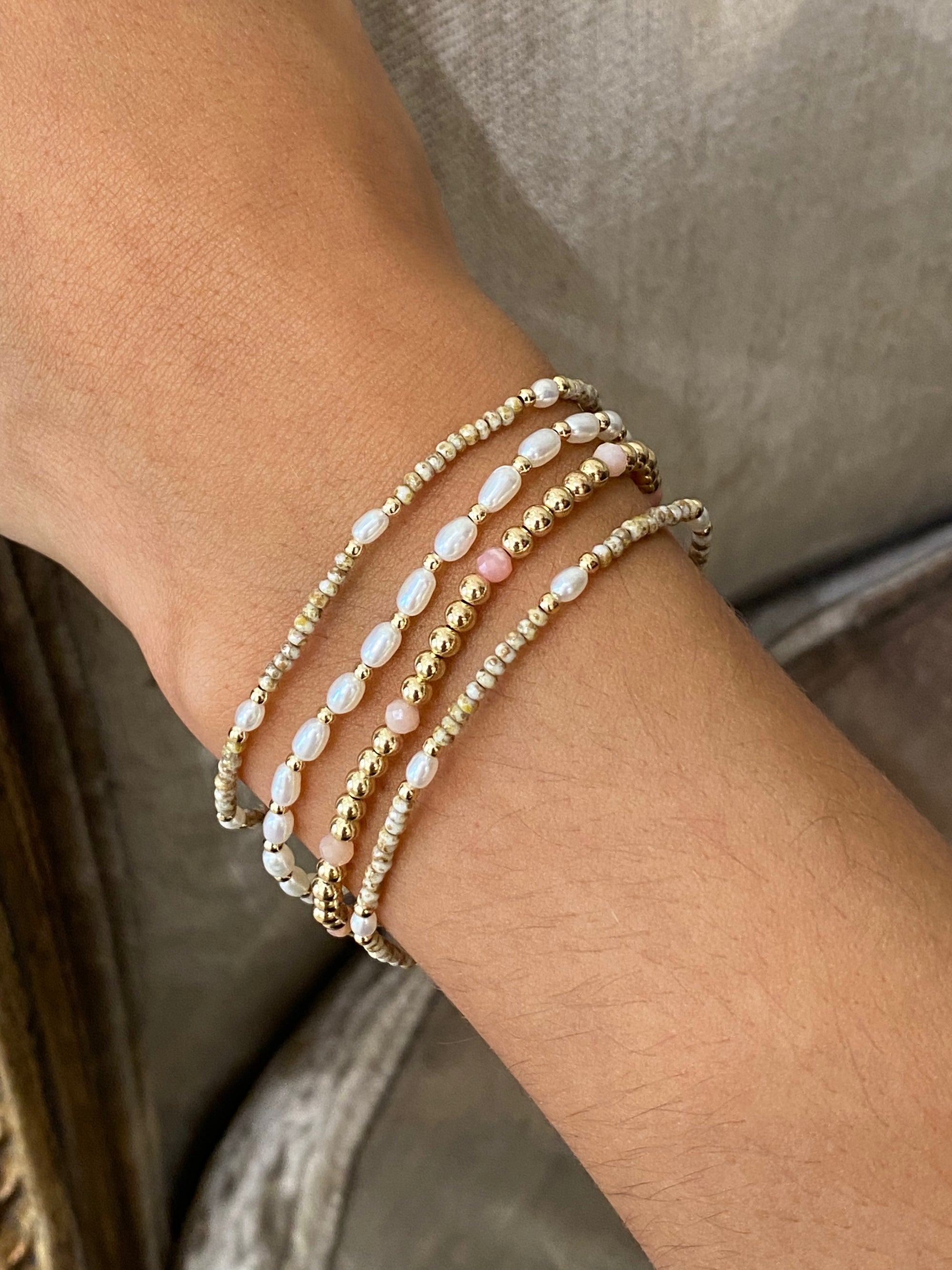 Woman wearing bracelet with freshwater Pearls and gold accent beads