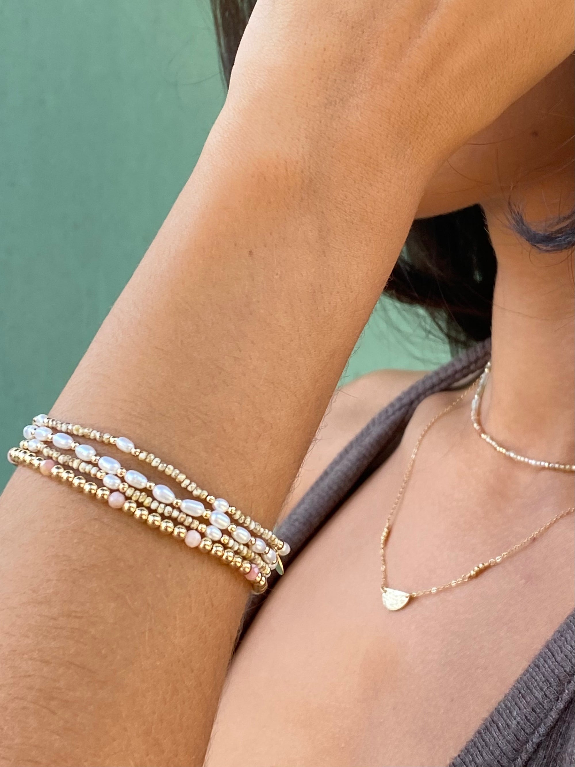 Woman wearing bracelet with freshwater Pearls and gold accent beads