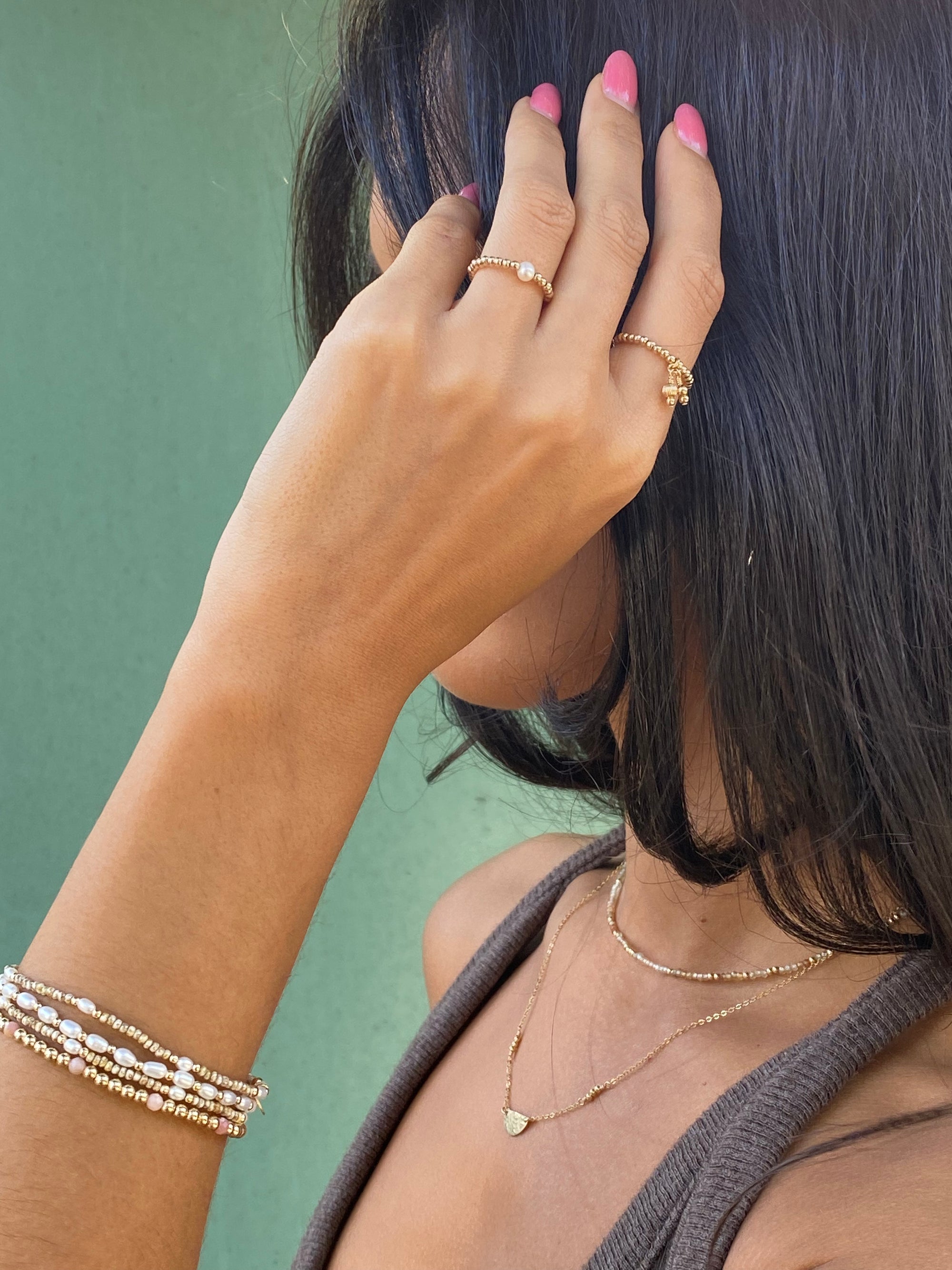 Woman wearing bracelet with freshwater Pearls and gold accent beads